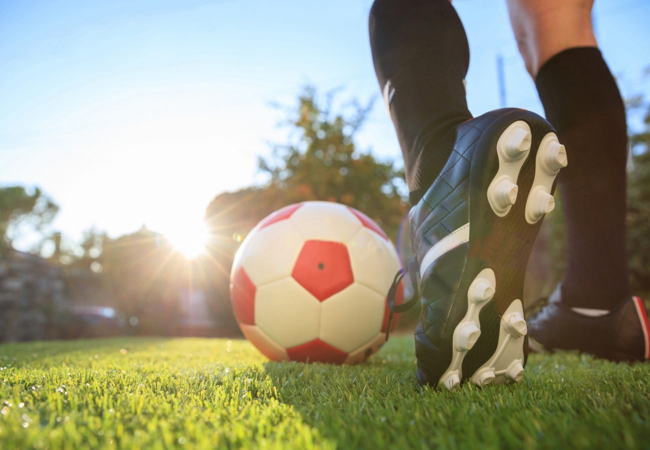 Woman and a soccer ball on the grass